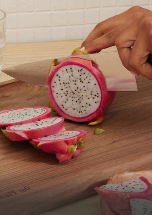 Everyday Chef's Knife cutting a dragonfruit on the Walnut Cutting Board