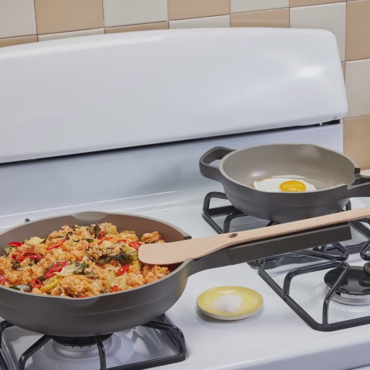 Transferring an egg from a black Mini Always Pan to a standard-size Always Pan