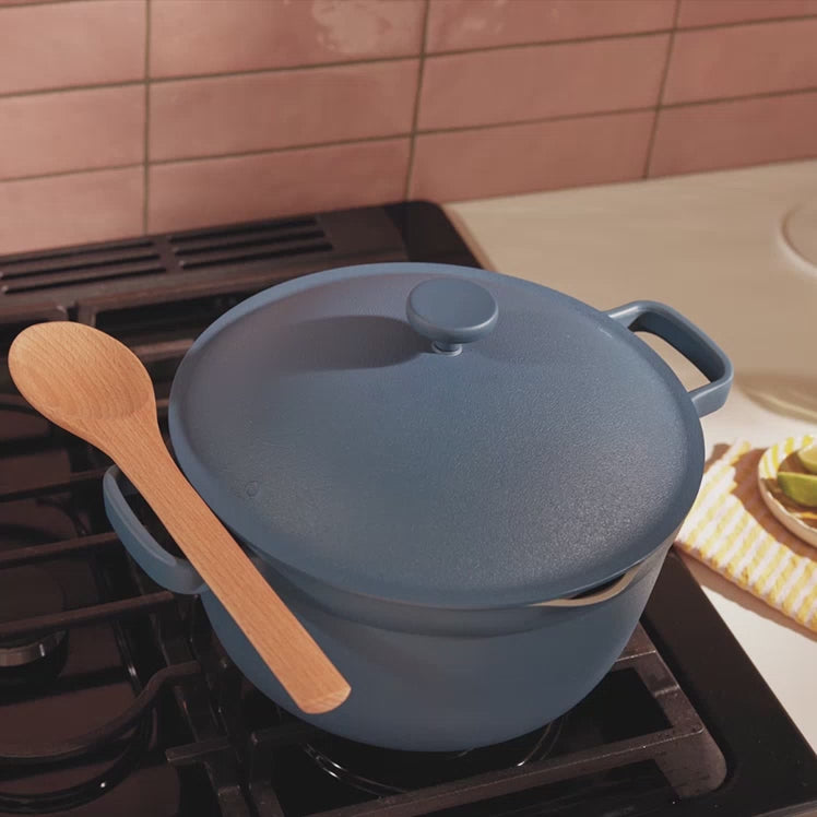 Stirring soup in a blue Perfect Pot using a notched Beechwood Spoon