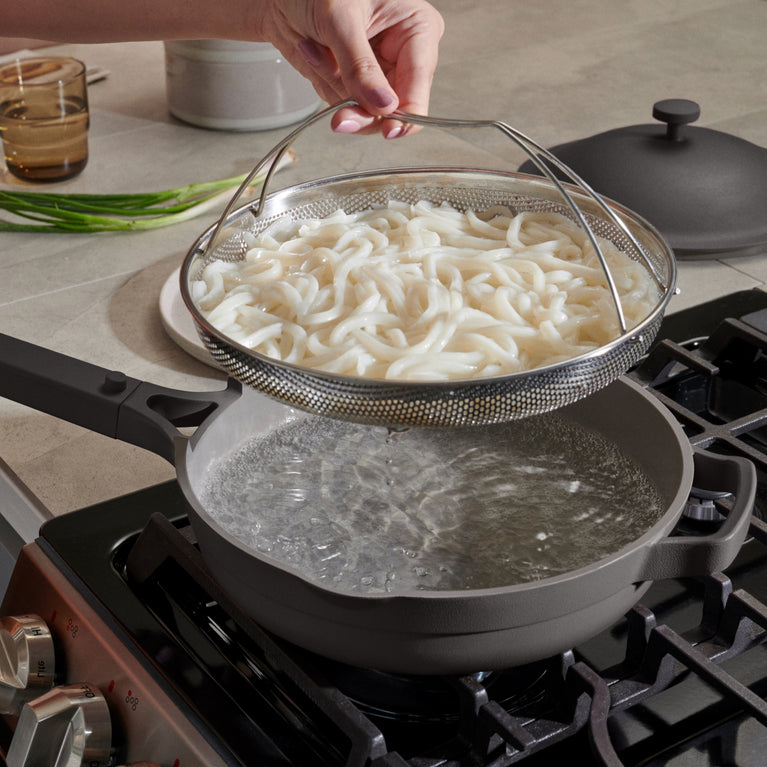 Black Always Pan on stovetop with noodles