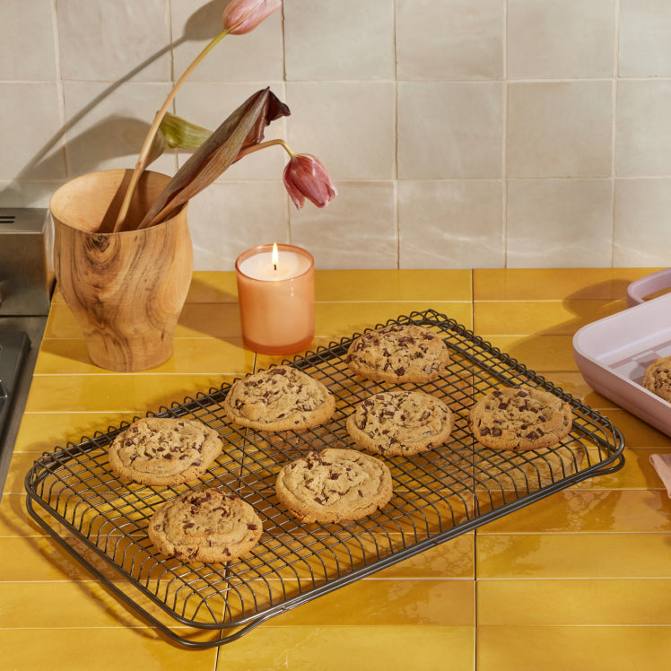 Black oven rack with cookies on countertop