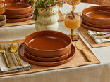 terracotta dinner bowl, salad plate and dinner plate on table 