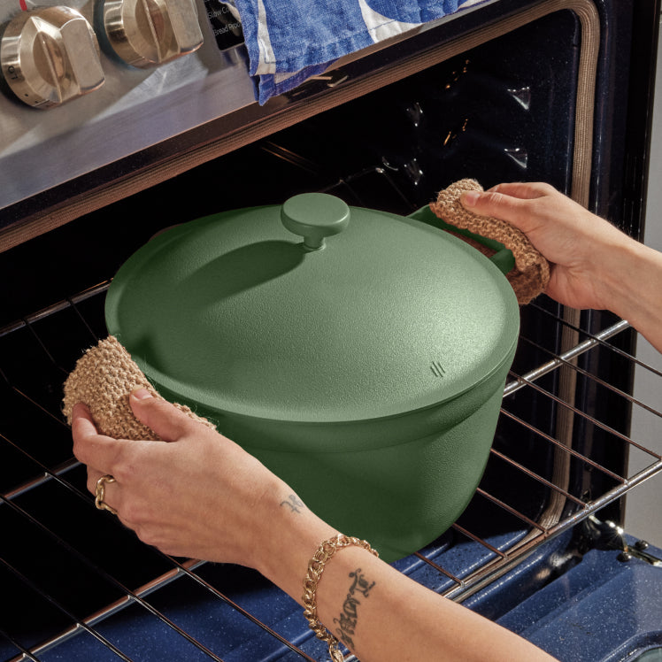 Removing a green Perfect Pot from the oven