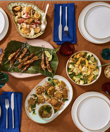 tablescape with dinnerware and meat skewers