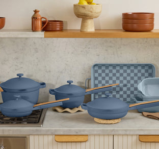 blue ultimate cookware set on counter and stove