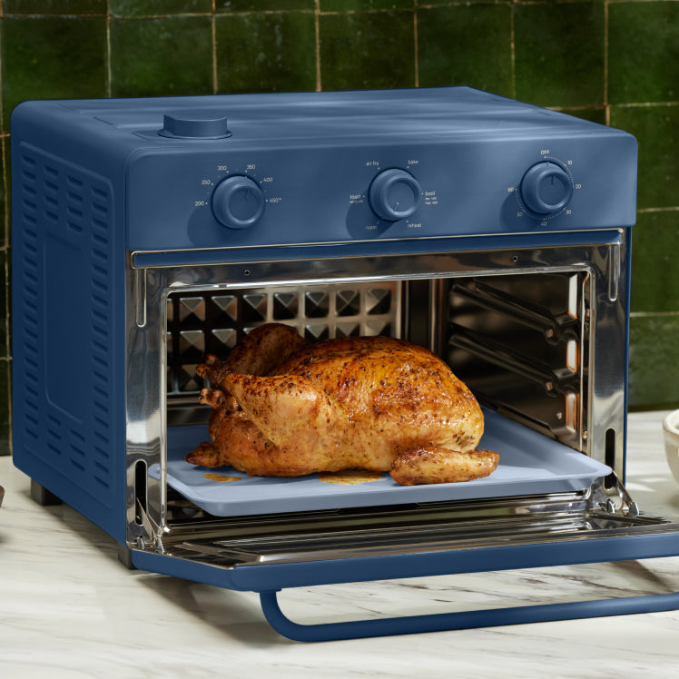 baking chicken in blue large wonder oven on counter