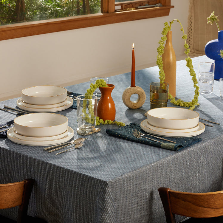 White dinnerware tablescape with blue tablecloth